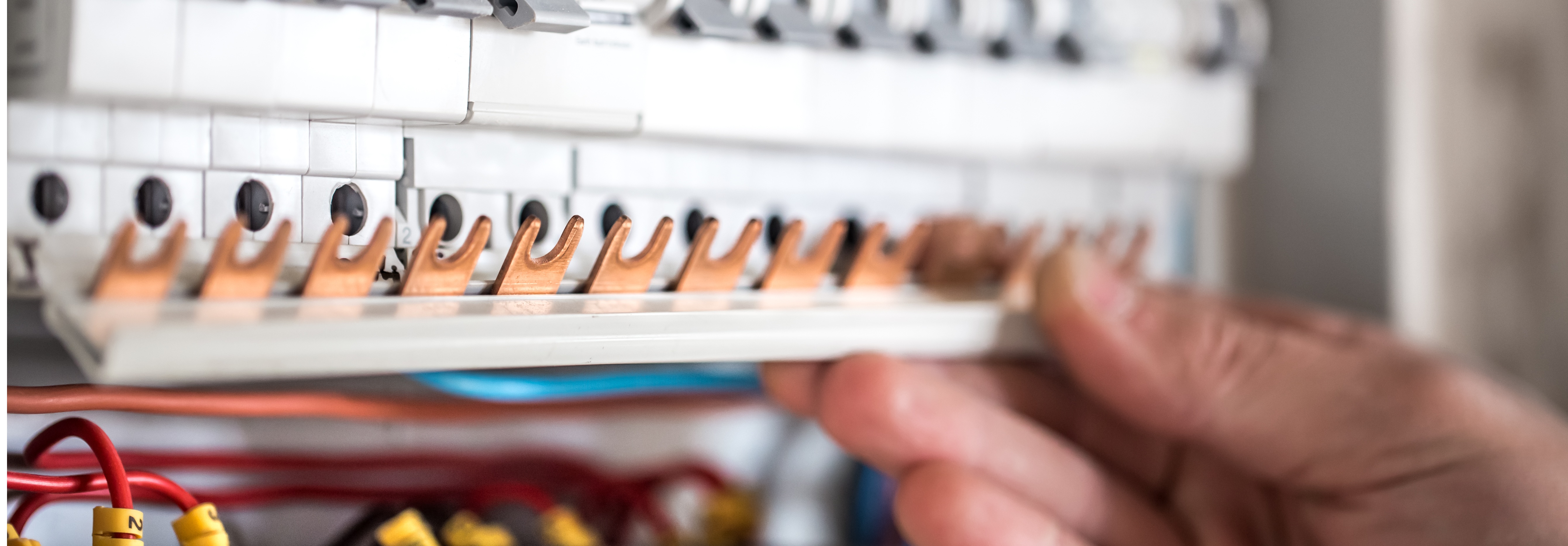 man electrical technician working switchboard with fuses installation connection electrical equipment close up